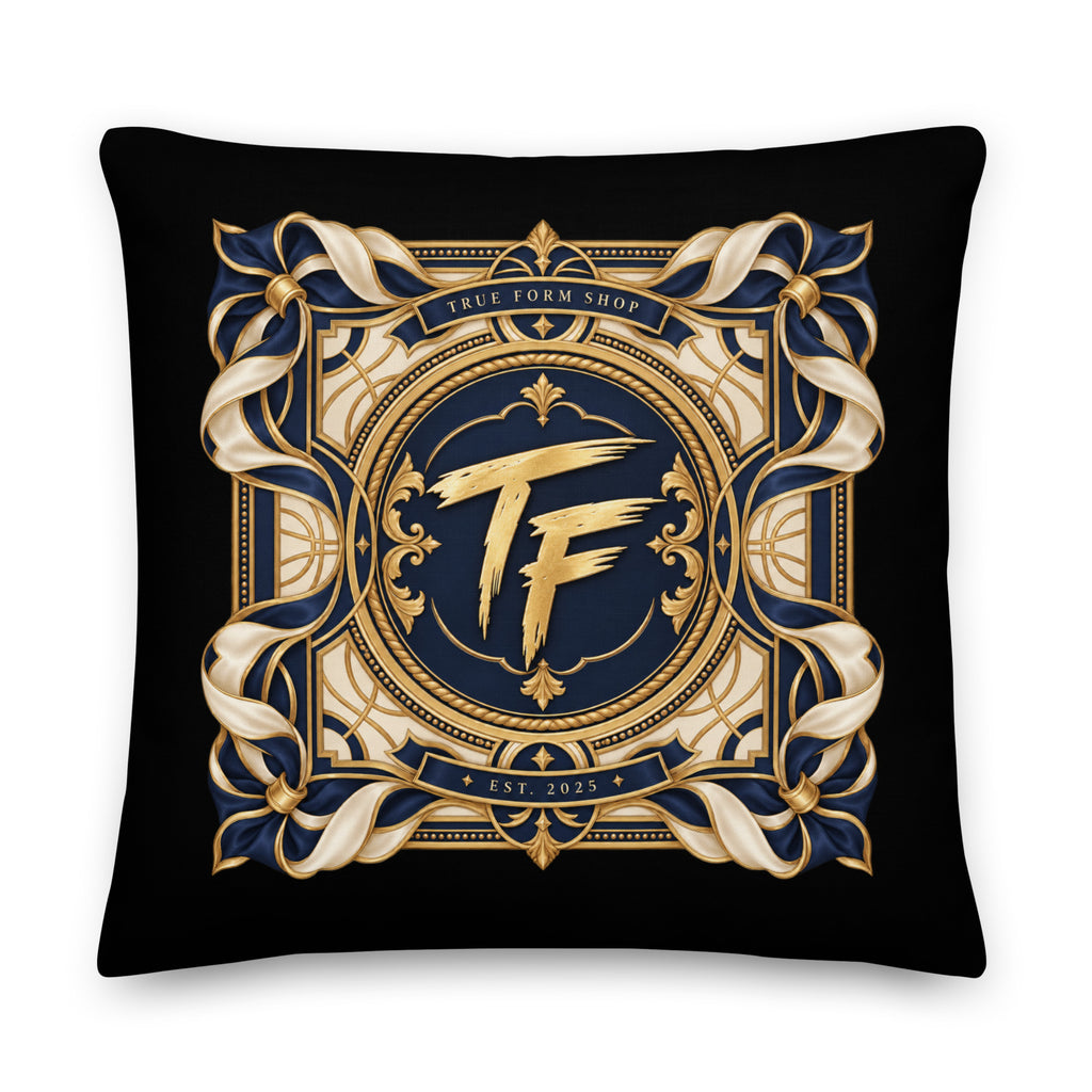 Back view of black True Form premium lifestyle pillow with a gold and navy ornate TF emblem and True Form Shop lettering.